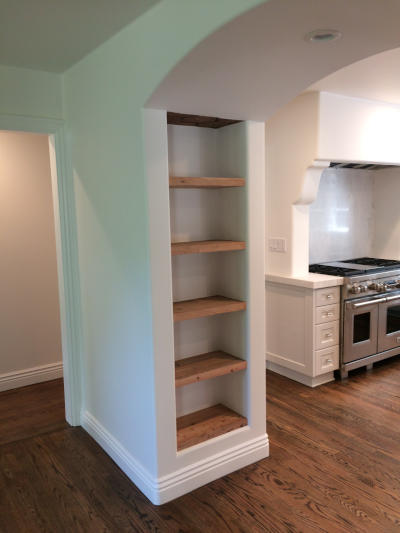 drywall-shelving-unit-modern Modern drywall shelving unit with wooden shelves in a kitchen